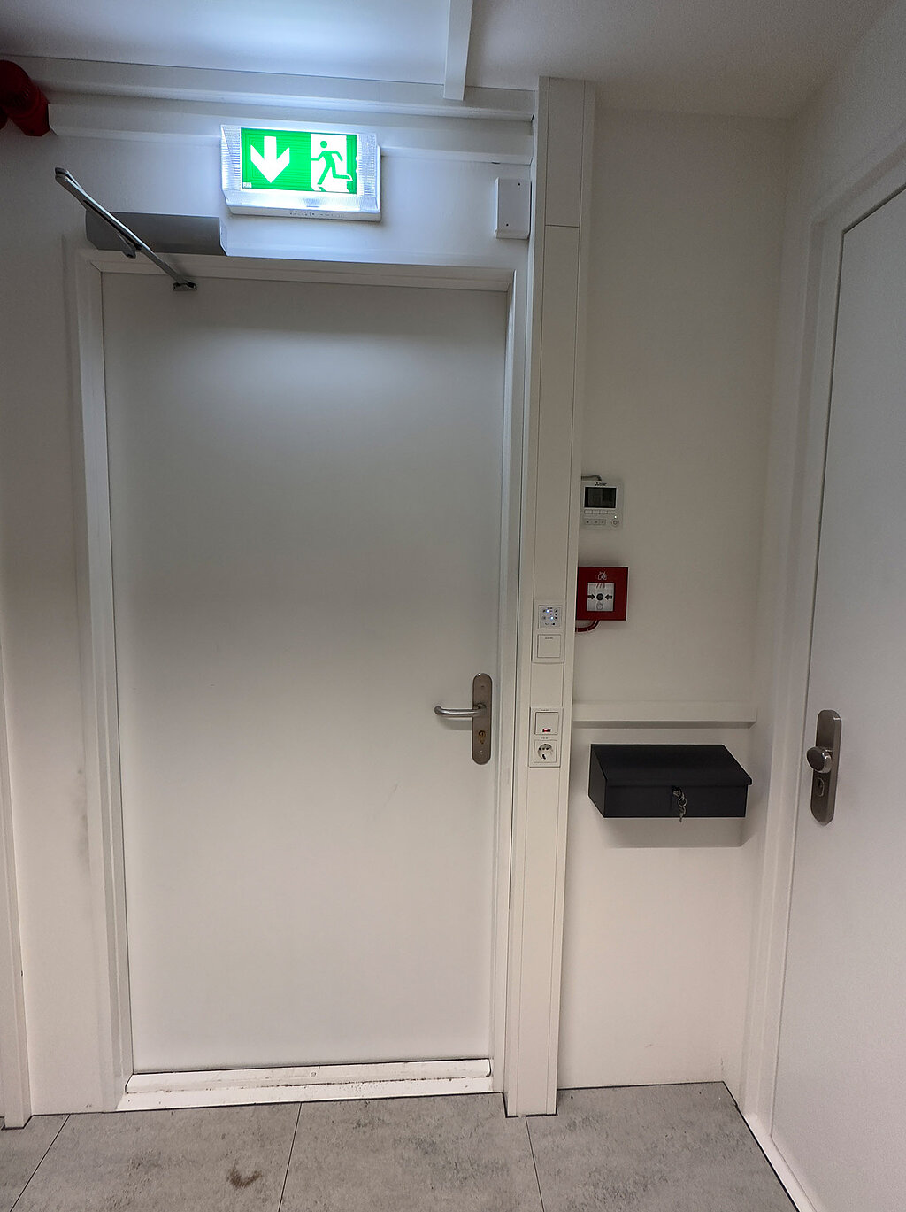 Door to server room with exit sign above it