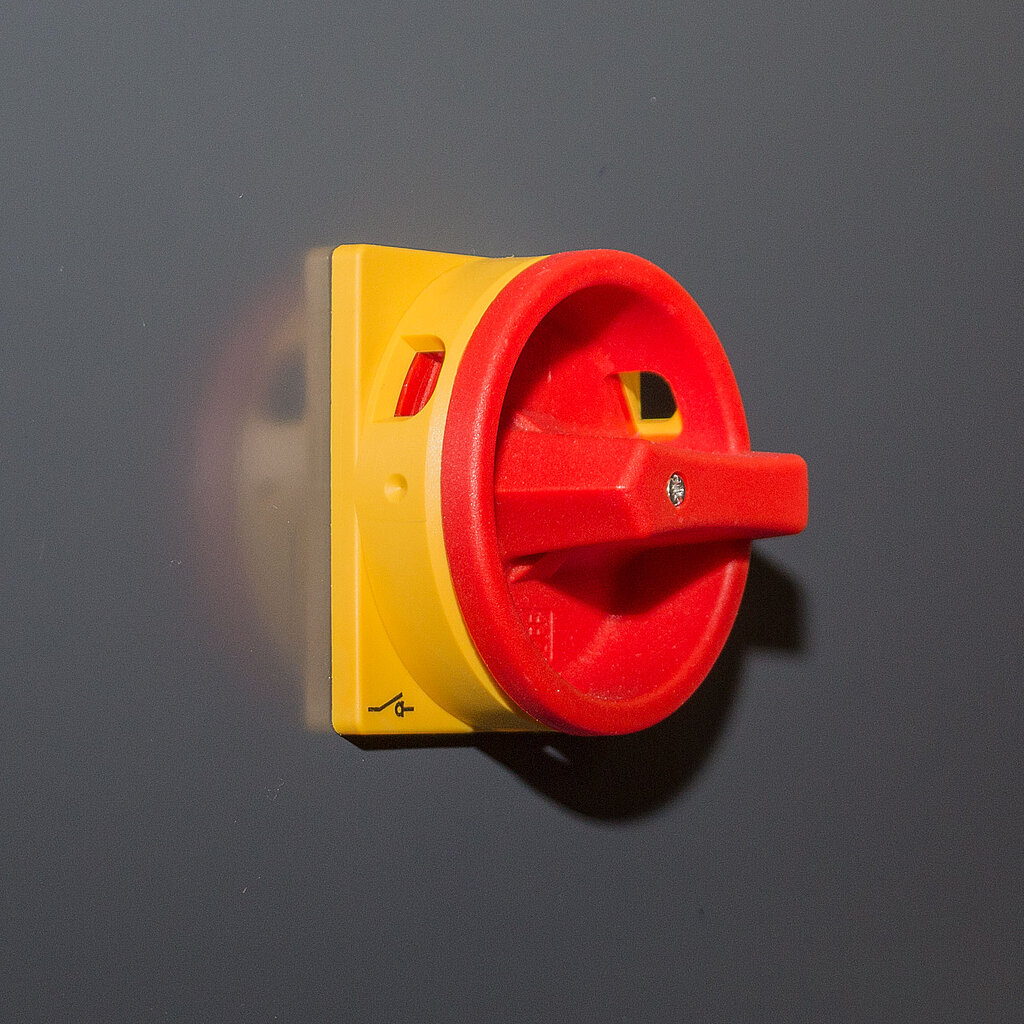 Emergency stop rotary switch above the rear service door
