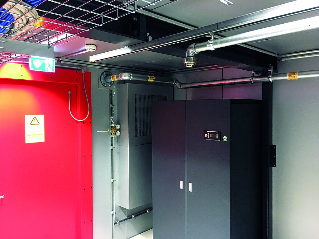 Cabinet in black on the right, red door to the data center on the left