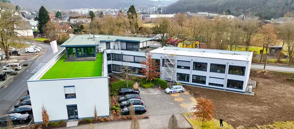 Das Firmengebäude der DCG aus der Luft mit diversen parkenden Autos