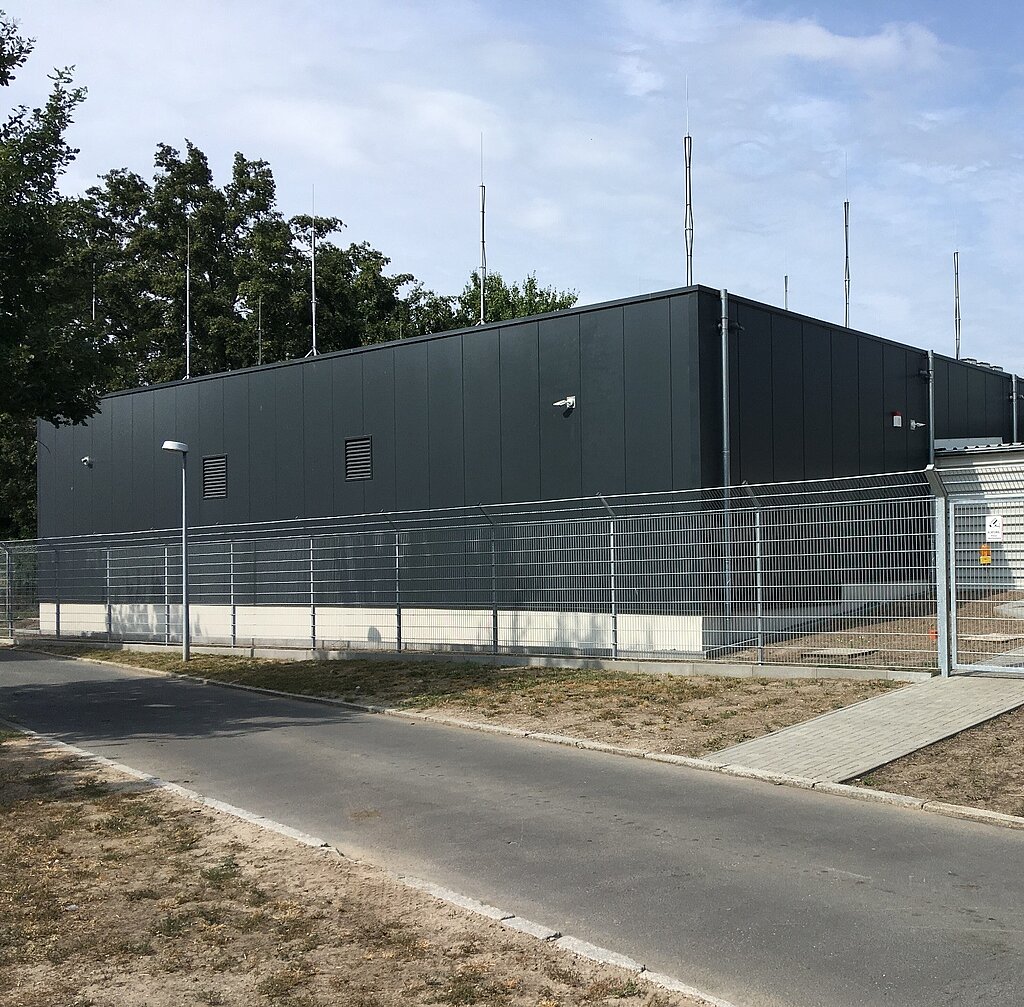 Data center with security fence and path in front of it