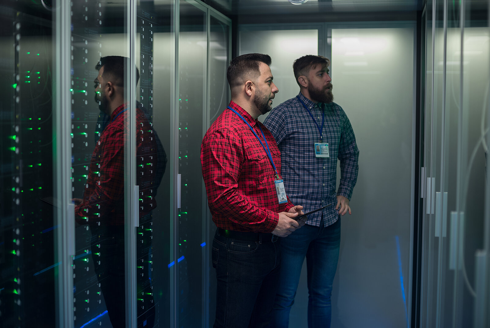 Two men in the data center looking at server racks