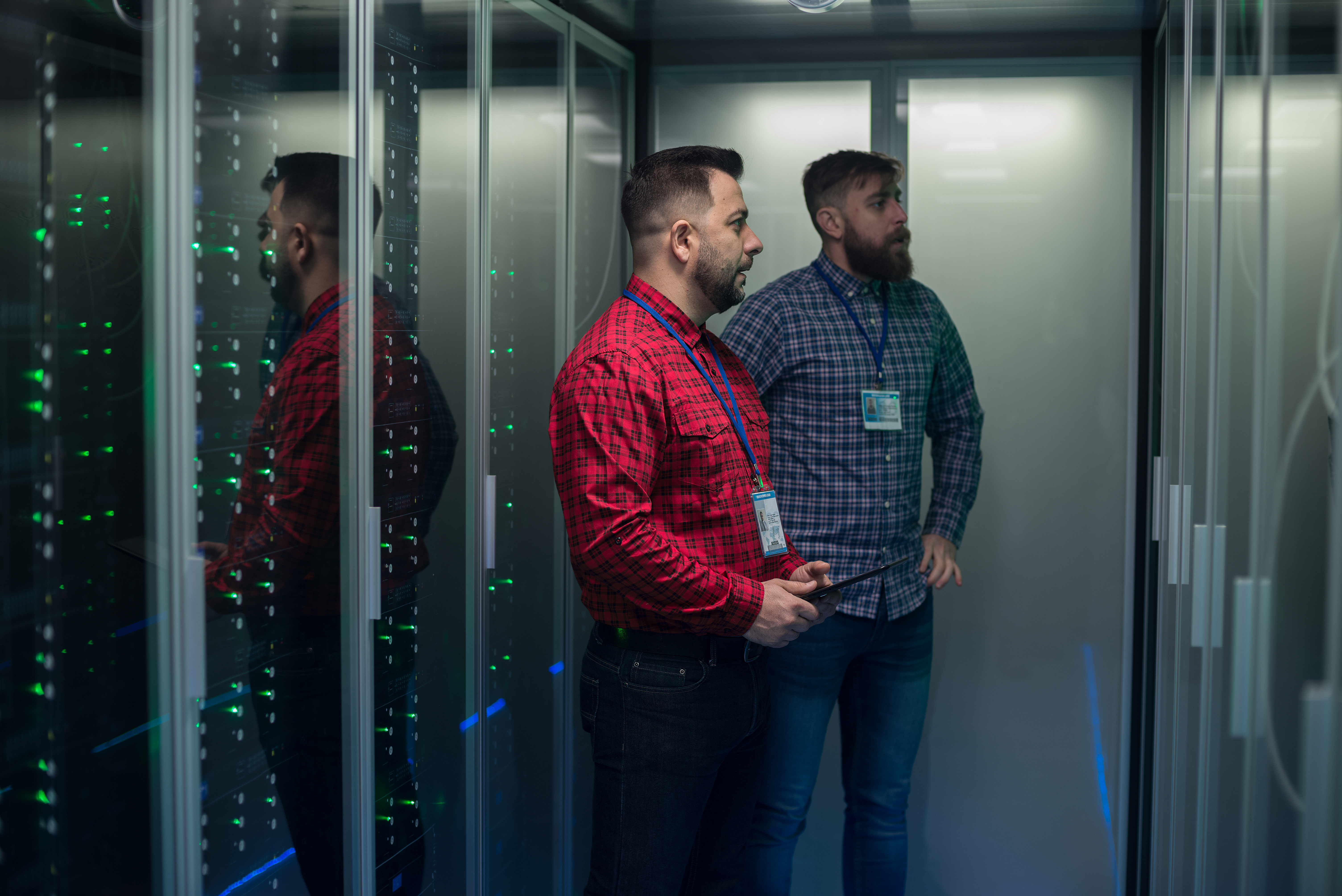Two men in the data center looking at server racks