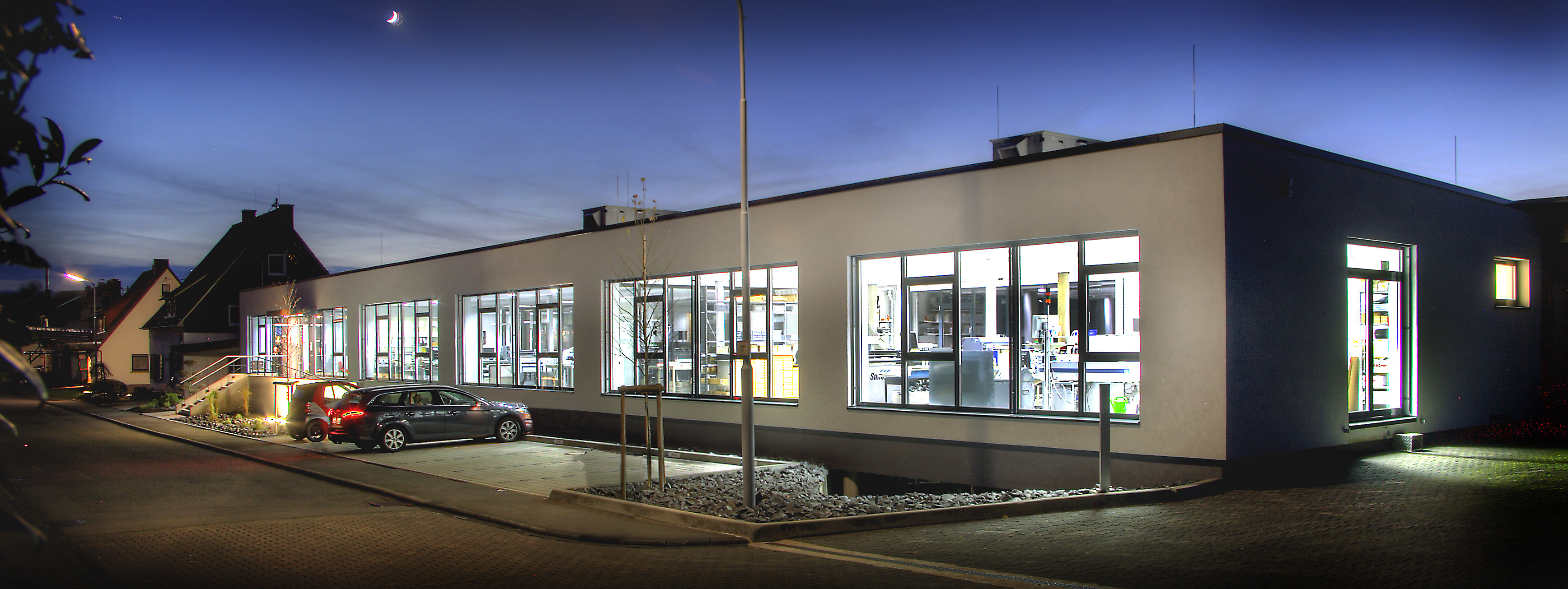 Wenzelmann sign factory building at night, illuminated