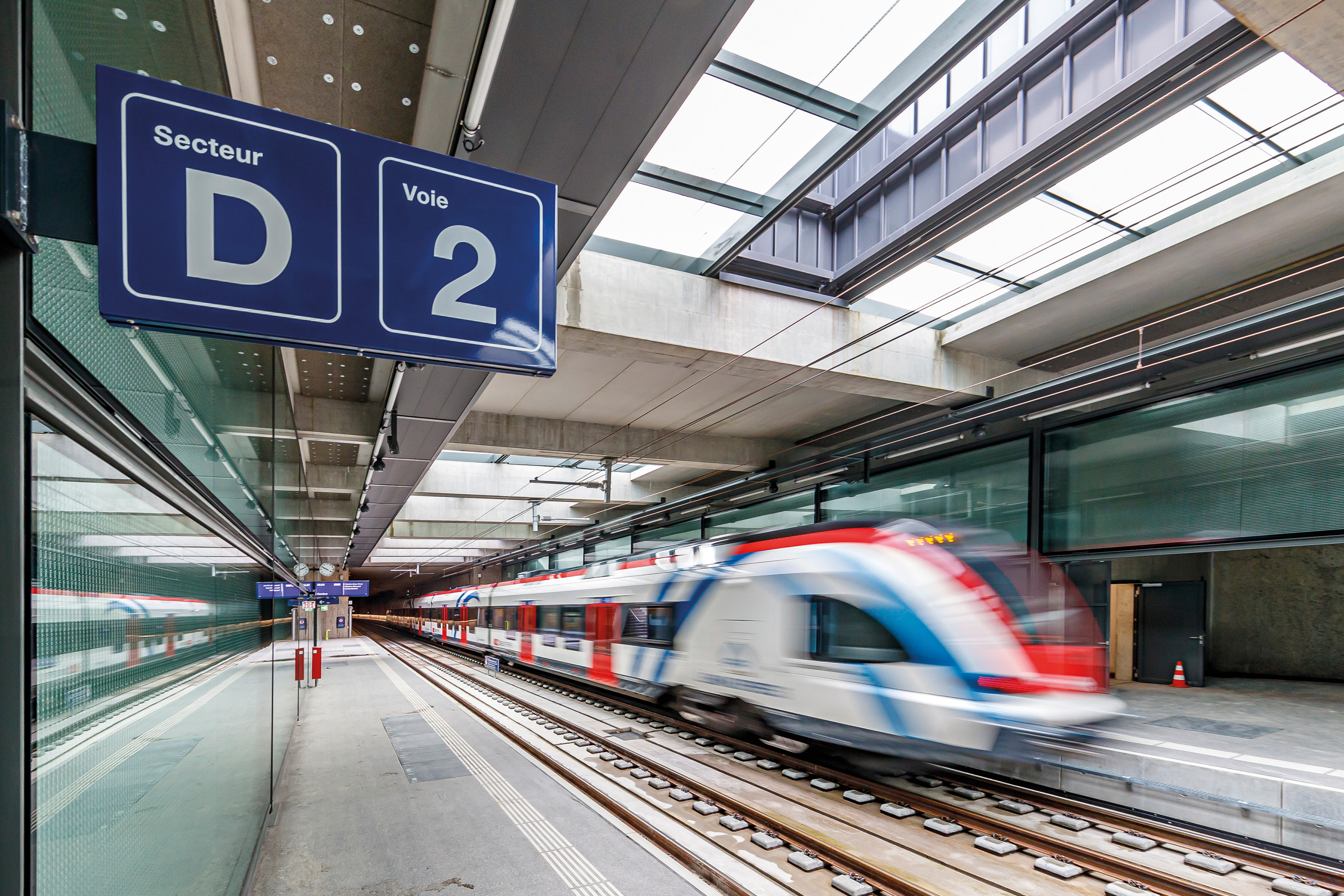 Arriving white train passing through a station